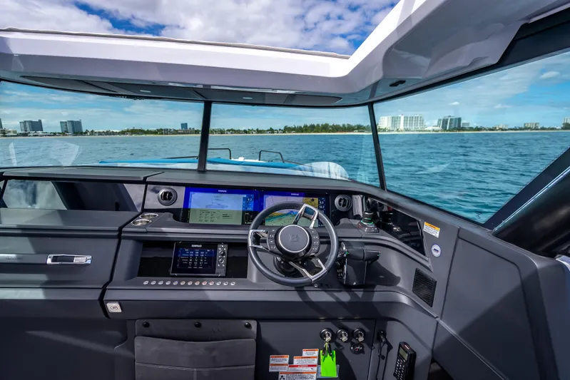  Yacht Photos Pics 2025 Axopar 45 Cross Top boat cockpit with modern navigation system and ocean view.