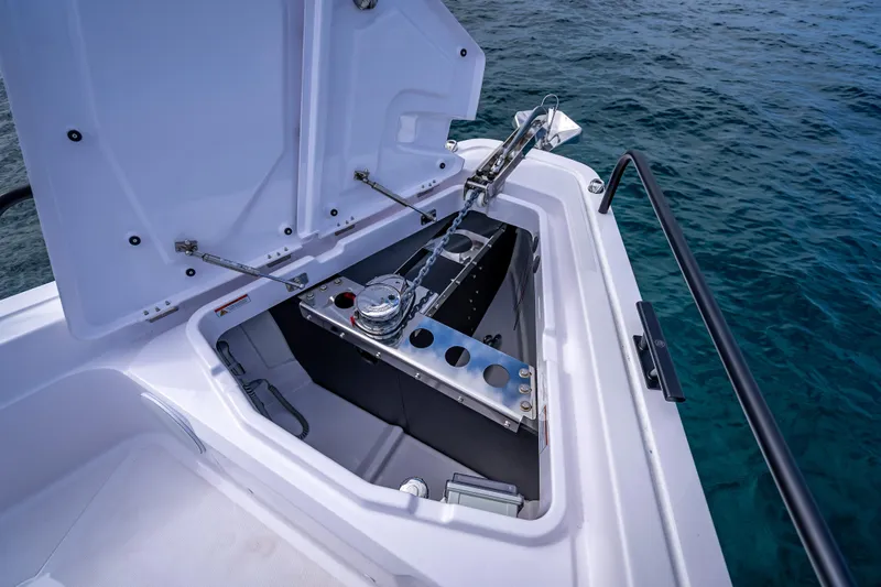  Yacht Photos Pics 2025 Axopar 45 Cross Top anchor compartment open, showcasing storage and winch system.
