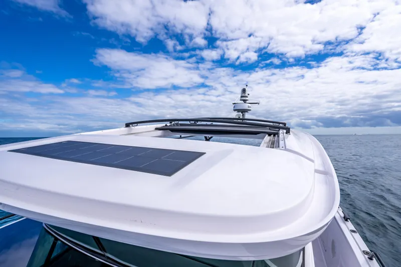  Yacht Photos Pics 2025 Axopar 45 Cross Top boat with solar panel under a blue sky.