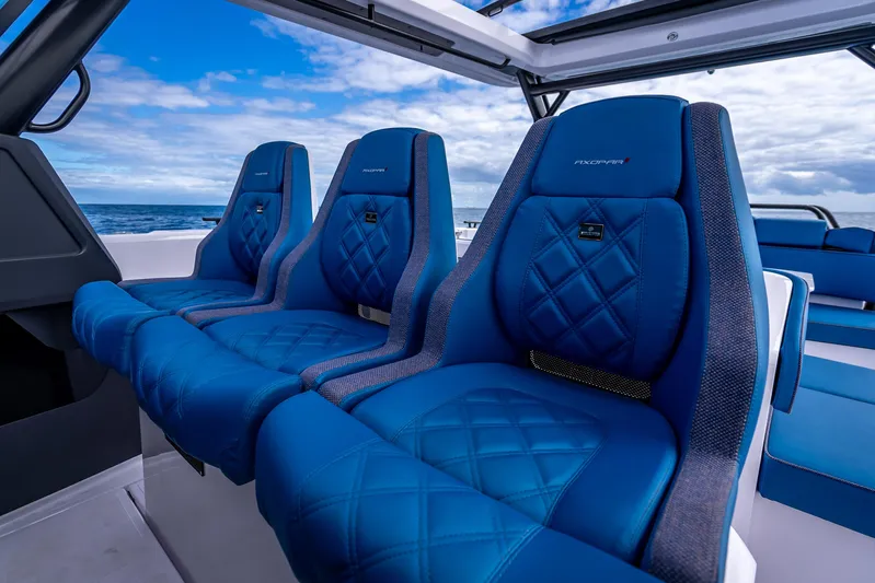  Yacht Photos Pics Luxurious blue seating on 2025 Axopar 45 Cross Top boat, ocean view.