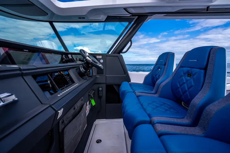  Yacht Photos Pics 2025 Axopar 45 Cross Top interior with blue seats and ocean view.