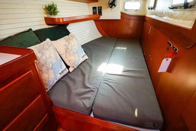 Mojo Yacht Photos Pics Cozy cabin interior of 2004 J Boats J/46 with comfortable bedding and nautical decor.