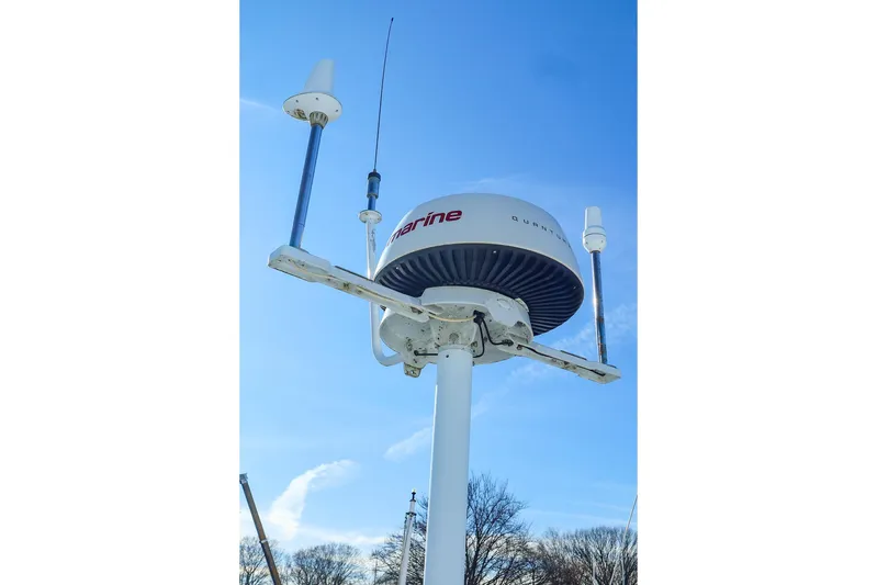 Mojo Yacht Photos Pics Radar and antennas on a 2004 J Boats J/46 sailboat against a clear blue sky.