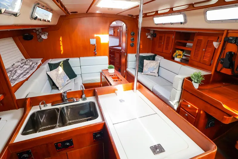 Mojo Yacht Photos Pics Luxurious 2004 J Boats J/46 yacht interior with elegant wood finish and cozy seating area.