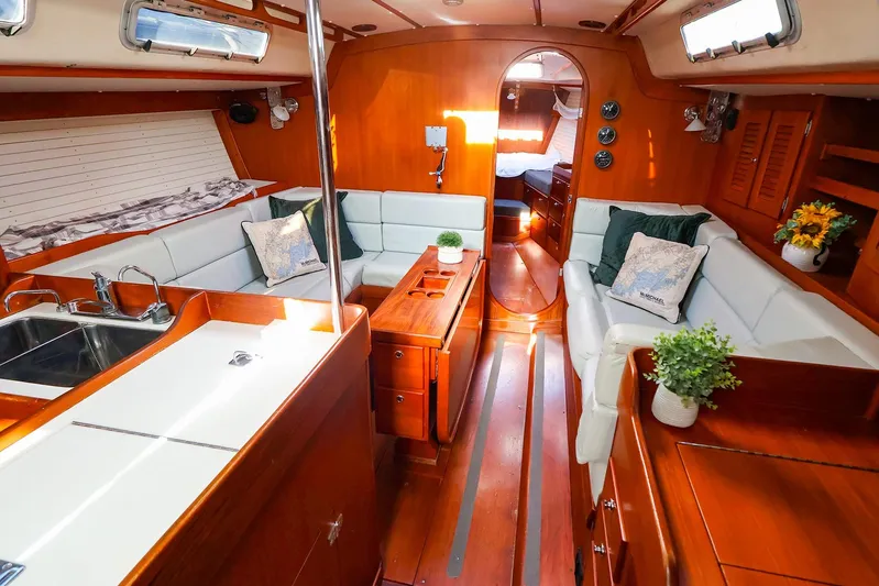 Mojo Yacht Photos Pics Luxurious 2004 J Boats J/46 yacht interior with elegant wood finish and cozy seating area.