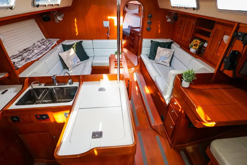 Mojo Yacht Photos Pics Luxurious 2004 J Boats J/46 yacht interior with elegant wood finish and cozy seating area.