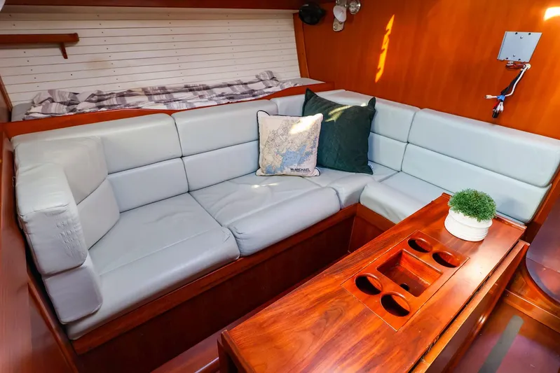 Mojo Yacht Photos Pics Luxurious interior of 2004 J Boats J/46 with plush seating and elegant wood finish.