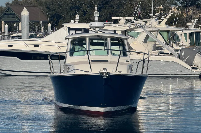 Indigo Yacht Photos Pics 2005 Back Cove 29 boat docked in a marina, surrounded by other vessels.