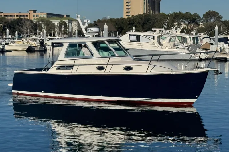 Indigo Yacht Photos Pics 2005 Back Cove 29 boat docked in a marina, reflecting on calm water.