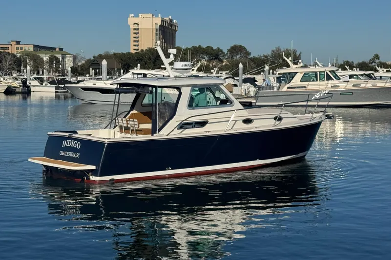 Indigo Yacht Photos Pics 2005 Back Cove 29 boat in marina, Charleston, SC, with clear blue sky.