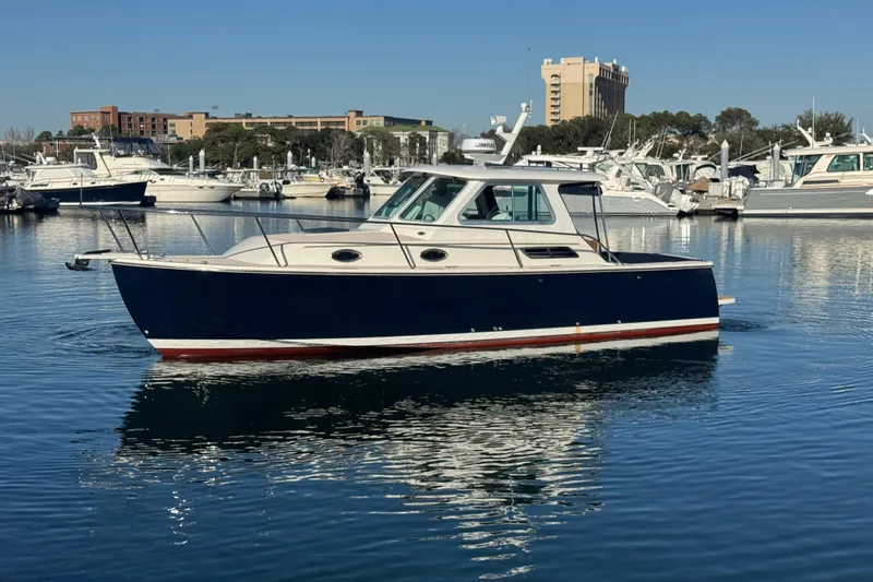 Indigo Yacht Photos Pics 2005 Back Cove 29 boat docked in a marina, surrounded by other vessels.
