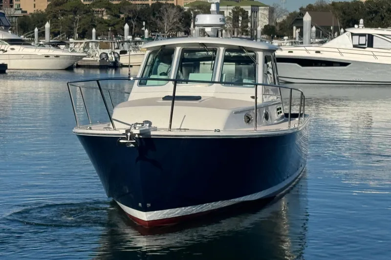 Indigo Yacht Photos Pics 2005 Back Cove 29 boat docked in a marina, front view.