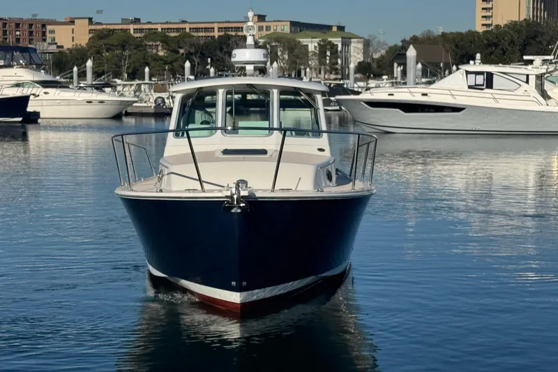 Indigo Yacht Photos Pics 2005 Back Cove 29 boat docked in a marina, surrounded by other vessels.