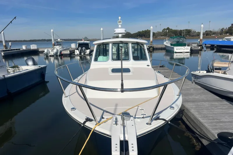 Indigo Yacht Photos Pics 2005 Back Cove 29 boat docked at a marina, surrounded by calm waters.