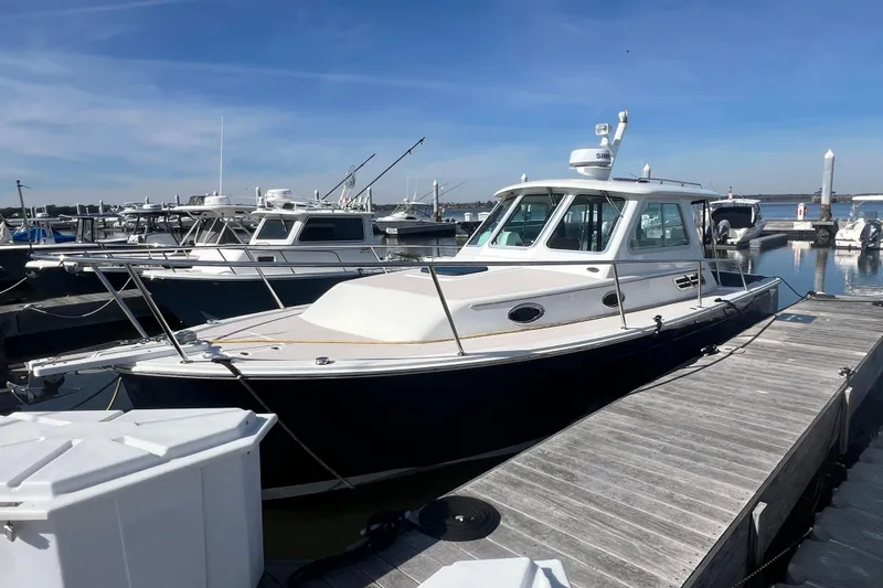 Indigo Yacht Photos Pics 2005 Back Cove 29 boat docked at marina under clear blue sky.