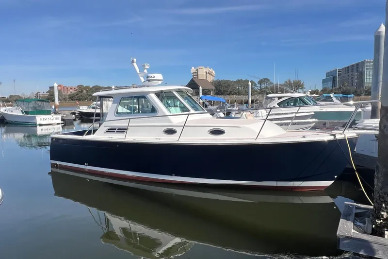 Indigo Yacht Photos Pics 2005 Back Cove 29 boat docked in a marina under clear blue skies.