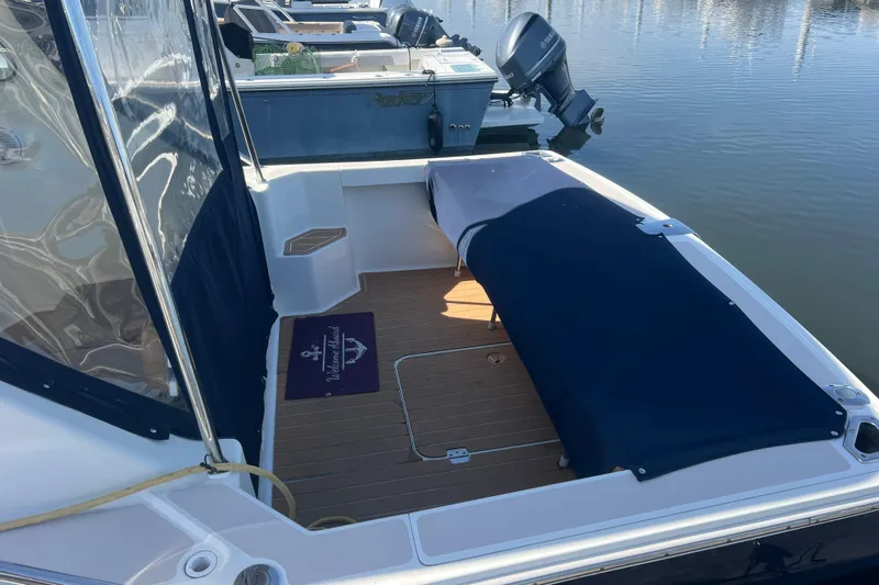 Indigo Yacht Photos Pics 2005 Back Cove 29 boat with covered seating area, docked at marina.