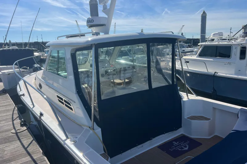 Indigo Yacht Photos Pics 2005 Back Cove 29 boat docked at marina under clear blue sky.
