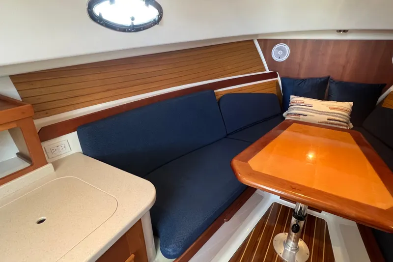 Indigo Yacht Photos Pics 2005 Back Cove 29 interior with blue seating, wooden table, and modern design elements.