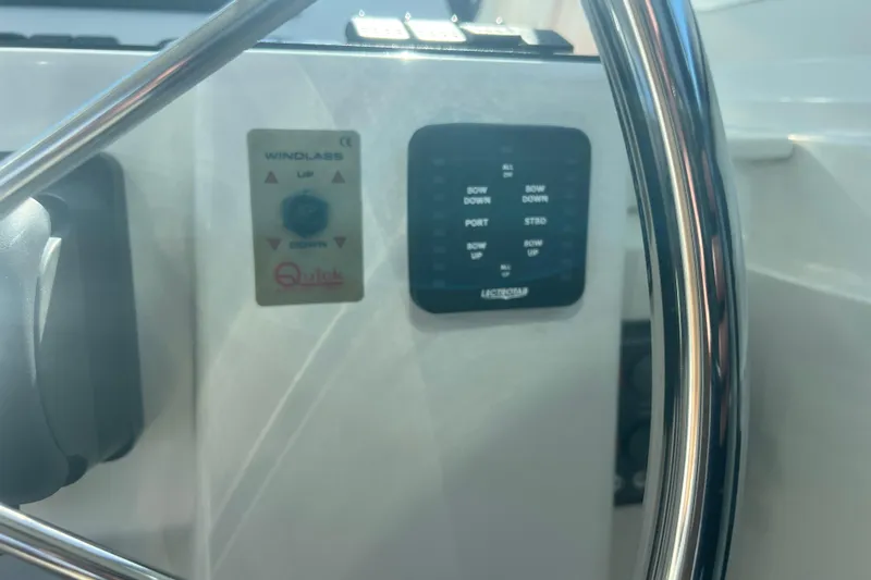 Indigo Yacht Photos Pics Control panel of a 2005 Back Cove 29 boat with steering wheel.