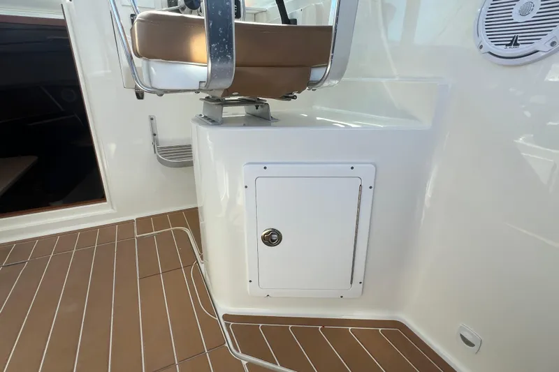 Indigo Yacht Photos Pics 2005 Back Cove 29 boat interior with brown seating and storage compartment.