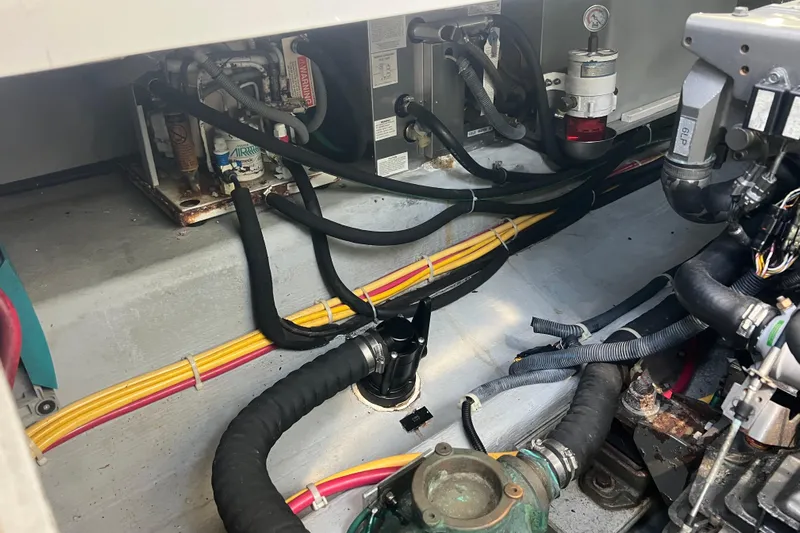 Indigo Yacht Photos Pics Engine compartment of a 2005 Back Cove 29 boat, showing hoses and wiring.