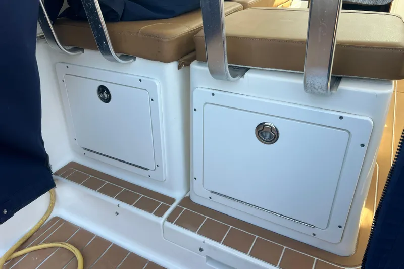 Indigo Yacht Photos Pics 2005 Back Cove 29 boat interior with storage compartments and cushioned seating.