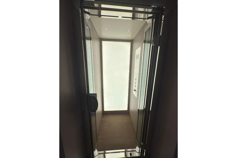 Mr. D Yacht Photos Pics Elevator interior on 2015 Benetti 140 yacht, featuring sleek design and modern lighting.