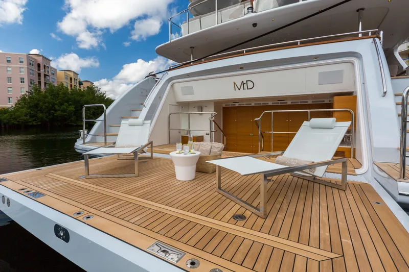 Mr. D Yacht Photos Pics Luxurious 2015 Benetti 140 yacht deck with sun loungers and drinks, under a clear blue sky.