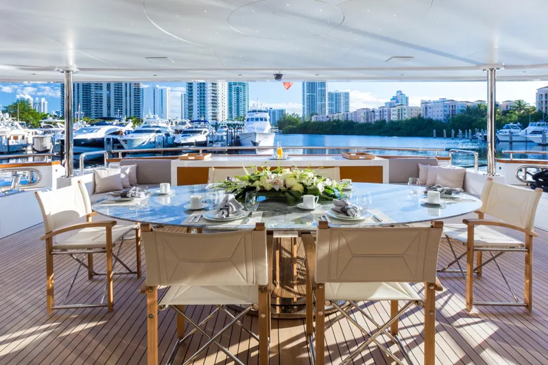 Mr. D Yacht Photos Pics Luxurious dining area on 2015 Benetti 140 yacht with marina view.