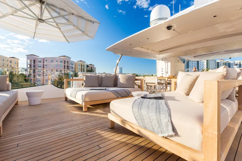 Mr. D Yacht Photos Pics Luxurious 2015 Benetti 140 yacht deck with elegant seating and cityscape view.