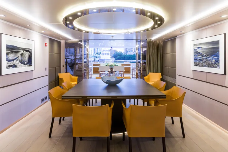 Mr. D Yacht Photos Pics Luxurious dining area on a 2015 Benetti 140 yacht with modern decor and elegant lighting.