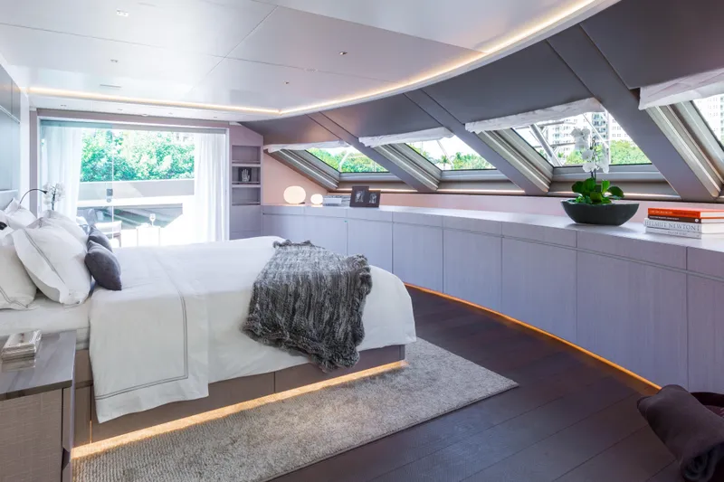 Mr. D Yacht Photos Pics Luxurious bedroom interior on a 2015 Benetti 140 yacht, featuring modern design and large windows.