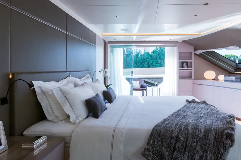 Mr. D Yacht Photos Pics Luxurious bedroom on a 2015 Benetti 140 yacht, featuring elegant decor and natural light.