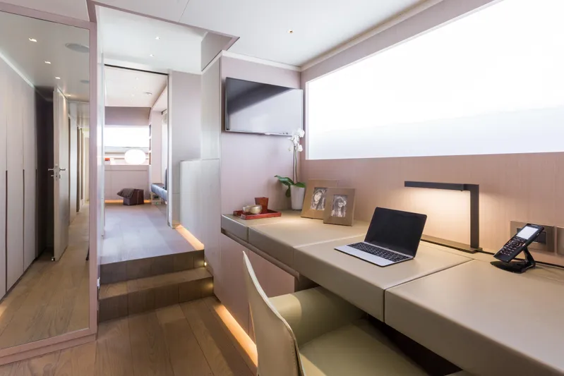 Mr. D Yacht Photos Pics Luxurious Benetti 140 yacht interior, featuring a modern office space with a laptop and elegant decor.