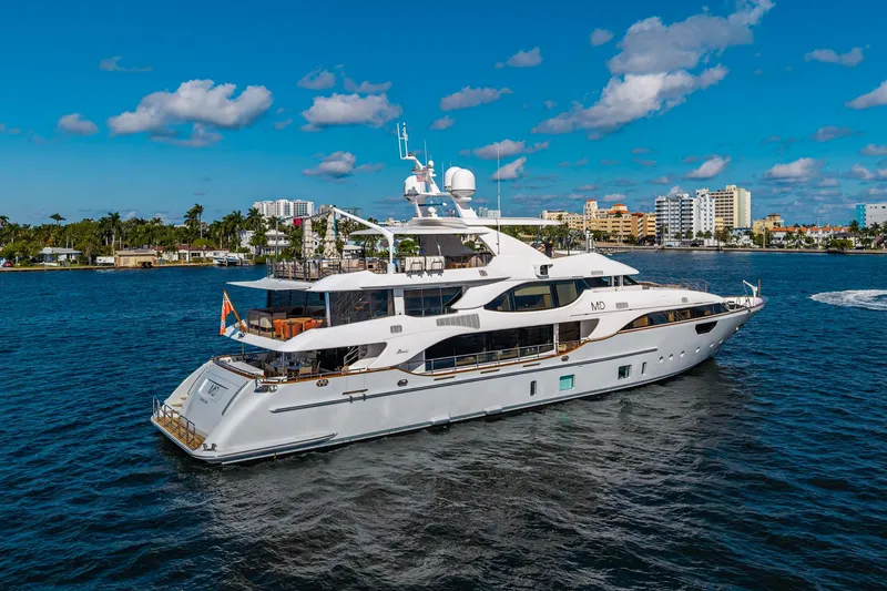 Mr. D Yacht Photos Pics Luxurious 2015 Benetti 140 yacht cruising on a sunny day near a coastal city.