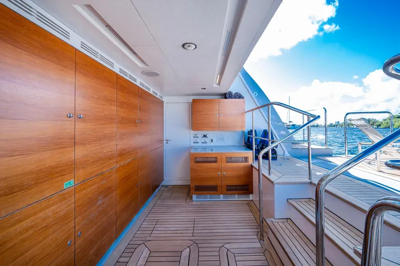 Mr. D Yacht Photos Pics Luxurious 2015 Benetti 140 yacht interior with wooden cabinetry and ocean view.