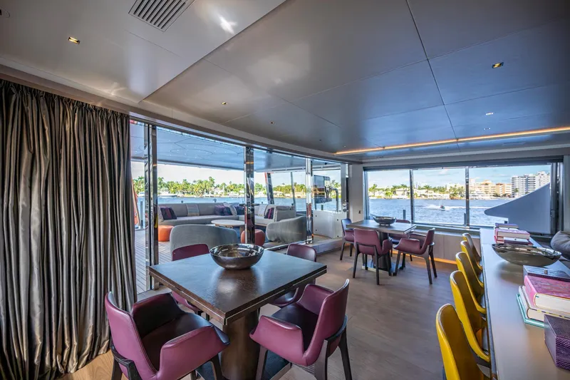 Mr. D Yacht Photos Pics Luxurious interior of 2015 Benetti 140 yacht with elegant dining area and waterfront view.