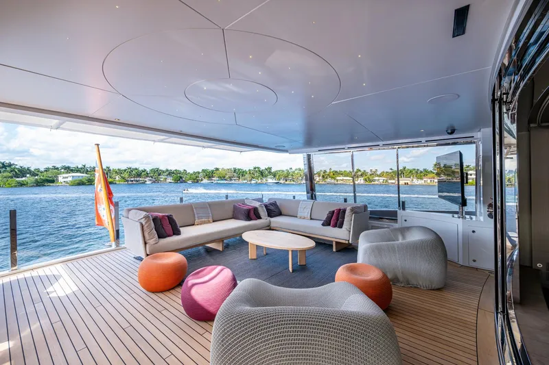 Mr. D Yacht Photos Pics Luxurious 2015 Benetti 140 yacht deck with modern seating and scenic waterfront view.