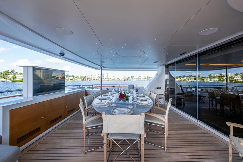 Mr. D Yacht Photos Pics Luxurious dining area on a 2015 Benetti 140 yacht, featuring elegant table settings and waterfront views.