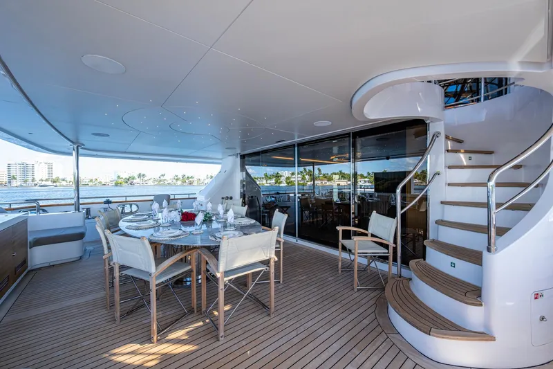 Mr. D Yacht Photos Pics Luxurious 2015 Benetti 140 yacht deck with elegant dining area and spiral staircase.