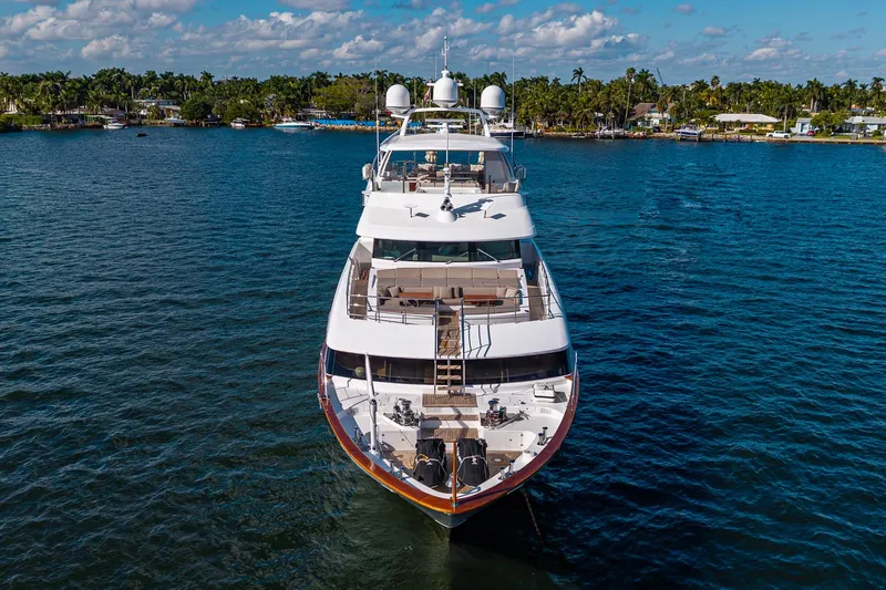 Mr. D Yacht Photos Pics Luxurious 2015 Benetti 140 yacht on serene blue waters, surrounded by lush greenery.