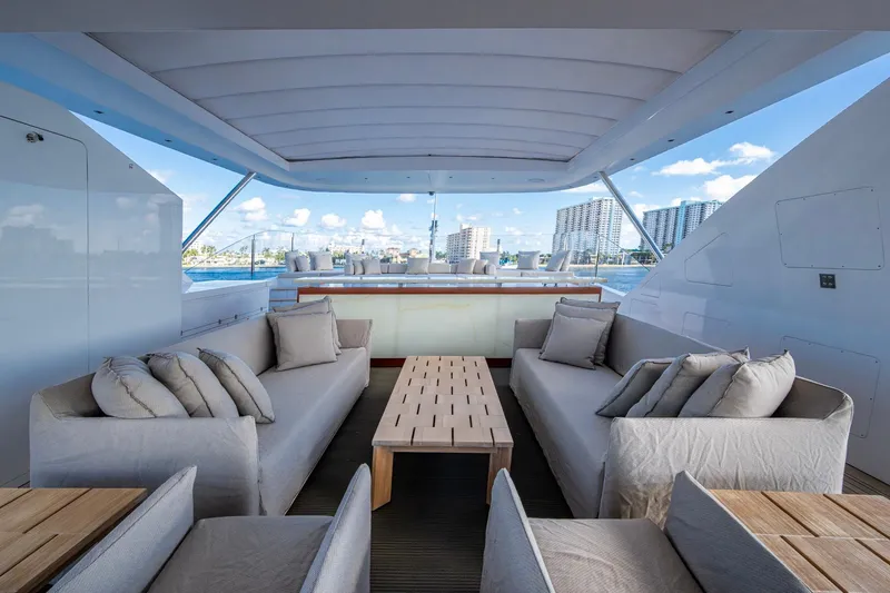 Mr. D Yacht Photos Pics Luxurious 2015 Benetti 140 yacht deck with elegant seating and cityscape views.