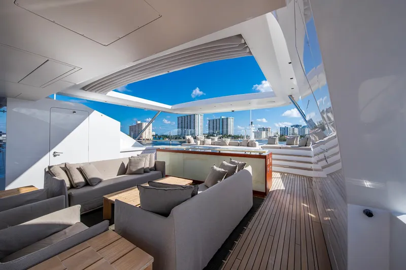 Mr. D Yacht Photos Pics Luxurious 2015 Benetti 140 yacht deck with modern seating and stunning cityscape views.