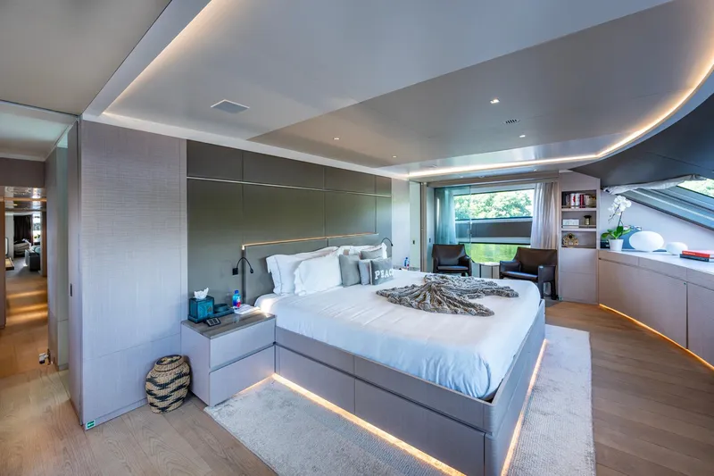 Mr. D Yacht Photos Pics Luxurious bedroom interior on 2015 Benetti 140 yacht, featuring modern design and ambient lighting.