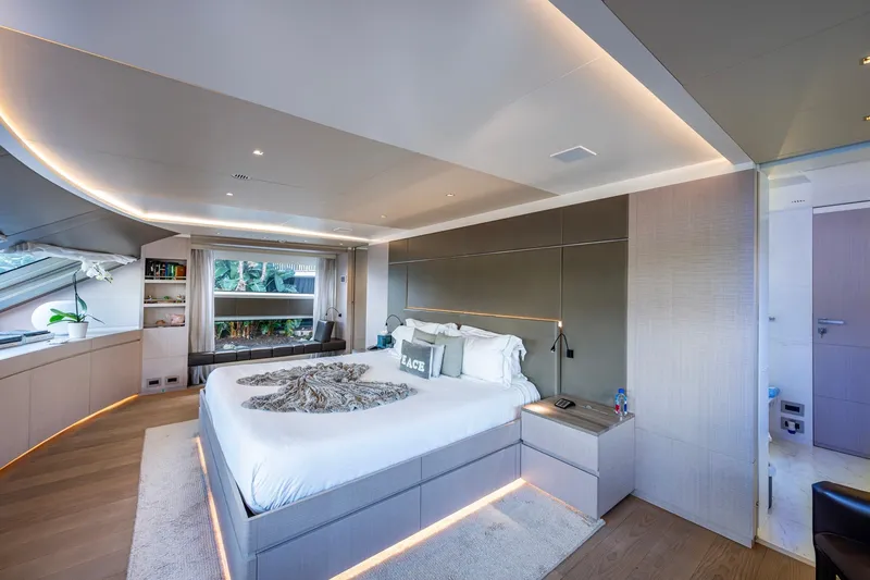 Mr. D Yacht Photos Pics Luxurious bedroom interior on 2015 Benetti 140 yacht, featuring modern design and ambient lighting.