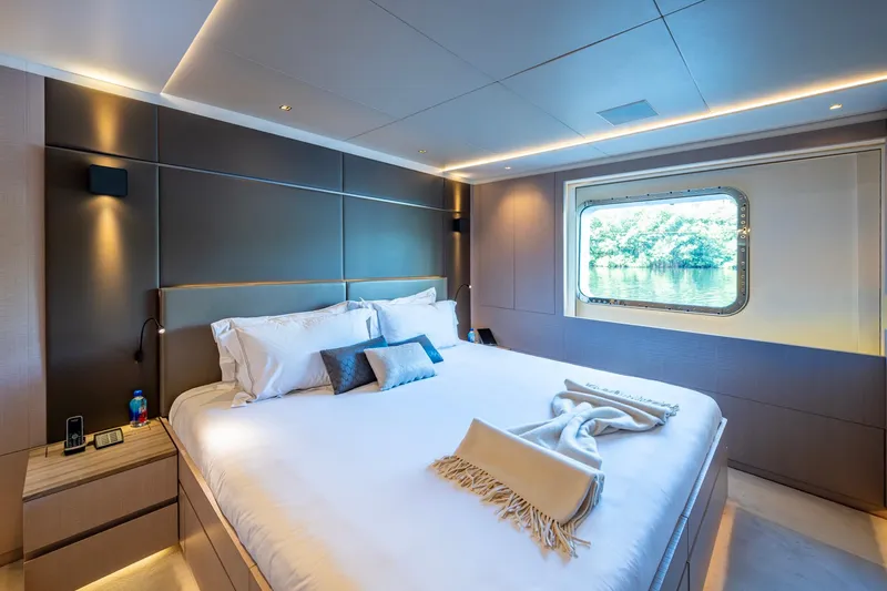 Mr. D Yacht Photos Pics Luxurious bedroom on a 2015 Benetti 140 yacht with scenic window view.