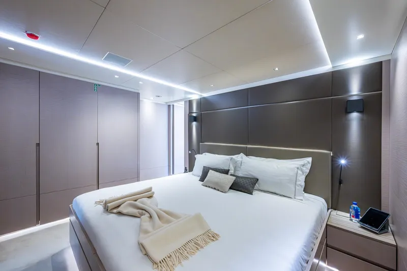 Mr. D Yacht Photos Pics Luxurious bedroom interior on 2015 Benetti 140 yacht, featuring modern design and ambient lighting.