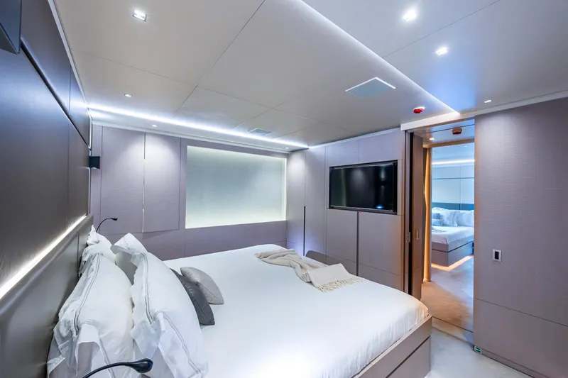 Mr. D Yacht Photos Pics Luxurious bedroom interior on a 2015 Benetti 140 yacht, featuring modern design and ambient lighting.