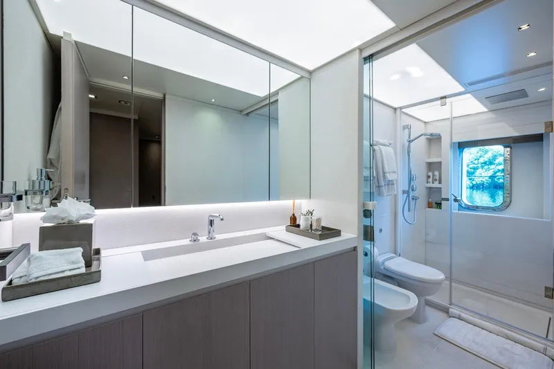 Mr. D Yacht Photos Pics Luxurious bathroom on 2015 Benetti 140 yacht with modern fixtures and ocean view.